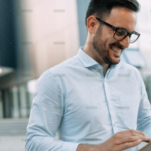 demo-attachment-609-portrait-of-businessman-in-glasses-holding-tablet-AWVHCJU